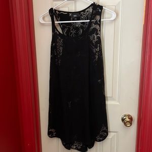 Sheer top with cool design. Flowy at bottom